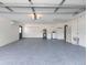 Spacious garage with blue epoxy floor and white walls, as well as a washer and dryer at 502 Duchess Dr, Lakeland, FL 33803