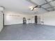 Spacious garage with epoxy floor, laundry area, shelving unit and ample room for storage at 502 Duchess Dr, Lakeland, FL 33803