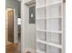 View of the hallway with an open door and shelving at 502 Duchess Dr, Lakeland, FL 33803