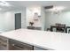 Bright kitchen featuring white quartz countertops, floating shelves, and stainless steel appliances at 502 Duchess Dr, Lakeland, FL 33803