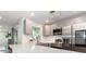 Modern kitchen with stainless appliances, quartz countertops and stylish pendant lighting at 502 Duchess Dr, Lakeland, FL 33803