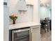 Stylish wet bar area with floating shelves and a beverage fridge near the dining area at 502 Duchess Dr, Lakeland, FL 33803