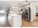 Open-concept kitchen with white cabinetry, stainless appliances and quartz countertops at 502 Duchess Dr, Lakeland, FL 33803