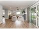 Open-concept living room with a sliding glass door, comfortable seating, and a decorative fireplace at 502 Duchess Dr, Lakeland, FL 33803