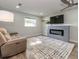 Spacious living room with ceiling fan, fireplace, and comfortable seating at 502 Duchess Dr, Lakeland, FL 33803