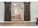 Wide doorway with open barn doors leading to light and airy living space with wood floors at 502 Duchess Dr, Lakeland, FL 33803