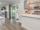 View of kitchen and living space with stainless steel appliances and access to backyard at 502 Duchess Dr, Lakeland, FL 33803