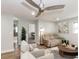 Bright living room with a ceiling fan, plush seating, and views into other rooms of the home at 502 Duchess Dr, Lakeland, FL 33803