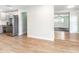 View of a modern kitchen with stainless appliances opening to an airy living room with wood flooring at 502 Duchess Dr, Lakeland, FL 33803