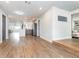 View of the open layout featuring the kitchen and living spaces with continuous wood flooring at 502 Duchess Dr, Lakeland, FL 33803