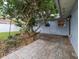 Charming brick patio shaded by a mature tree and a garden with landscape lighting at 502 Duchess Dr, Lakeland, FL 33803