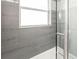 Close up of a shower with gray tiled walls and decorative tile accents at 502 Duchess Dr, Lakeland, FL 33803