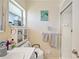Bathroom features white vanity, shower, and tile floor, with window for natural light at 512 Cameo Dr, Lakeland, FL 33803