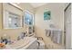Well-lit bathroom features a shower and tub, white vanity, and tile floors at 512 Cameo Dr, Lakeland, FL 33803