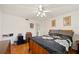 Well-lit bedroom features wood floors, ceiling fan, and ensuite bathroom at 512 Cameo Dr, Lakeland, FL 33803