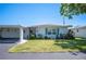 Charming single-story home with well-maintained lawn and vibrant landscaping enhancing curb appeal at 512 Cameo Dr, Lakeland, FL 33803
