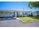 Inviting single-story home with carport, lush lawn, and vibrant landscaping at 512 Cameo Dr, Lakeland, FL 33803