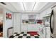 Classic kitchen with white cabinets, appliances, and checkerboard flooring at 512 Cameo Dr, Lakeland, FL 33803