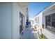 Bright patio with white furniture, sliding glass doors, and blue recycling container at 512 Cameo Dr, Lakeland, FL 33803
