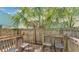 Backyard wooden deck featuring outdoor seating and a partial view of the lush landscaping at 523 W Hancock St, Lakeland, FL 33803