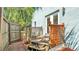Small backyard deck with a wooden railing, two chairs, and a view of the yard at 523 W Hancock St, Lakeland, FL 33803
