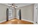 Bright bedroom with wood floors, fan, and two windows providing natural light at 523 W Hancock St, Lakeland, FL 33803