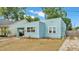 Charming blue home with a covered parking area, landscaping, and a paved driveway at 523 W Hancock St, Lakeland, FL 33803