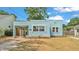 Well-maintained light blue home with a covered parking spot and tidy landscaping at 523 W Hancock St, Lakeland, FL 33803