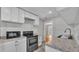 Updated kitchen with white cabinets, stainless steel appliances, and modern countertops at 523 W Hancock St, Lakeland, FL 33803