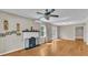 Spacious living room with hardwood floors, a decorative fireplace, and a ceiling fan at 523 W Hancock St, Lakeland, FL 33803
