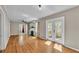 Open living room with hardwood floors, fireplace, and bright French doors leading to the outdoors at 523 W Hancock St, Lakeland, FL 33803