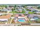 Aerial view of a home with a screened in pool, outdoor kitchen, backyard, privacy fence and solar panels at 5246 Montserrat Dr, Lakeland, FL 33812