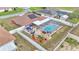 Aerial view of a home with a screened in pool, outdoor kitchen, backyard and privacy fence at 5246 Montserrat Dr, Lakeland, FL 33812
