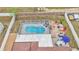 Aerial view of a home with fenced backyard featuring a screened-in pool and outdoor dining area at 5246 Montserrat Dr, Lakeland, FL 33812