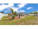 An exterior view of the home’s backyard featuring a screened in pool, outdoor furniture, and landscaping at 5246 Montserrat Dr, Lakeland, FL 33812