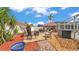 Landscaped backyard area with patio furniture, firepit, BBQ, and screened-in pool at 5246 Montserrat Dr, Lakeland, FL 33812