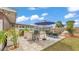 Entertain in your backyard that features a bar with seating, an outdoor dining table, and a fire pit near the pool at 5246 Montserrat Dr, Lakeland, FL 33812