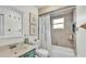 Bathroom with tiled shower, a sink with counter, large framed mirror, and floral accents at 5246 Montserrat Dr, Lakeland, FL 33812