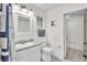 Bright bathroom featuring a single sink vanity, toilet, window, framed mirror, and walk-in shower at 5246 Montserrat Dr, Lakeland, FL 33812