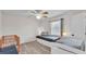 Bedroom with hardwood floors, white walls, ceiling fan, and a window with blinds at 5246 Montserrat Dr, Lakeland, FL 33812