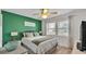 Green accent wall Primary bedroom with two windows, hardwood floors, and ceiling fan at 5246 Montserrat Dr, Lakeland, FL 33812