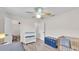 Bedroom with wood floors, white walls, a changing table, crib, and a blue trunk at 5246 Montserrat Dr, Lakeland, FL 33812