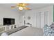 Bedroom features bi-fold closet doors, ceiling fan, TV, neutral paint, and wood floors at 5246 Montserrat Dr, Lakeland, FL 33812