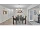 Dining room features modern chandelier, dark wood table and chairs, and backyard access at 5246 Montserrat Dr, Lakeland, FL 33812