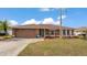 Charming single-story home boasts a well-manicured lawn, mature landscaping, and inviting curb appeal at 5246 Montserrat Dr, Lakeland, FL 33812