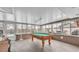 Entertain in this large sunroom with a pool table, lots of light, and durable flooring at 5246 Montserrat Dr, Lakeland, FL 33812