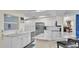 Bright and spacious kitchen with white cabinets, stainless steel appliances, and a large marble island at 5246 Montserrat Dr, Lakeland, FL 33812