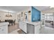 Open concept kitchen with white cabinets, marble countertops, stainless steel appliances, and backyard access at 5246 Montserrat Dr, Lakeland, FL 33812