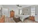 Bright main bedroom features a ceiling fan, wood laminate flooring, and walk-in closet access at 5246 Montserrat Dr, Lakeland, FL 33812