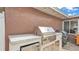 Outdoor grill with granite counter space, storage, and stainless steel appliances ready for grilling and entertaining at 5246 Montserrat Dr, Lakeland, FL 33812